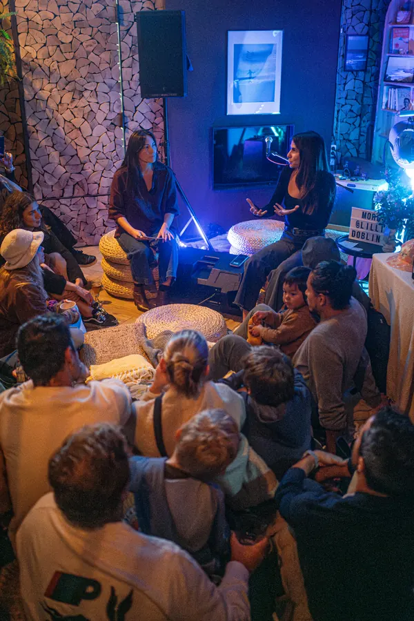 An evening talk with the audience seated on the floor