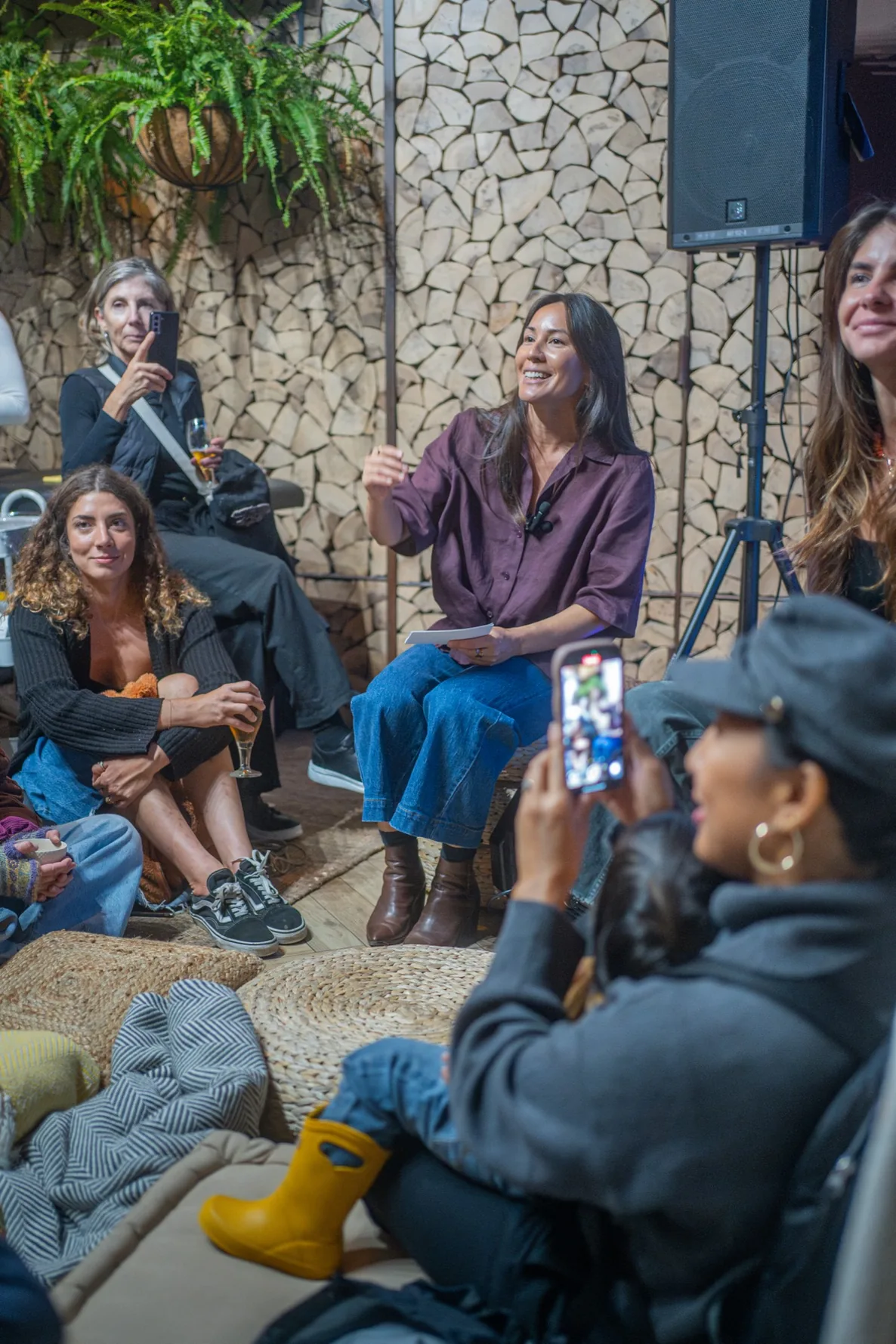 Jennifer Nunez smiling as she talks with a group gathered around her at an evening event