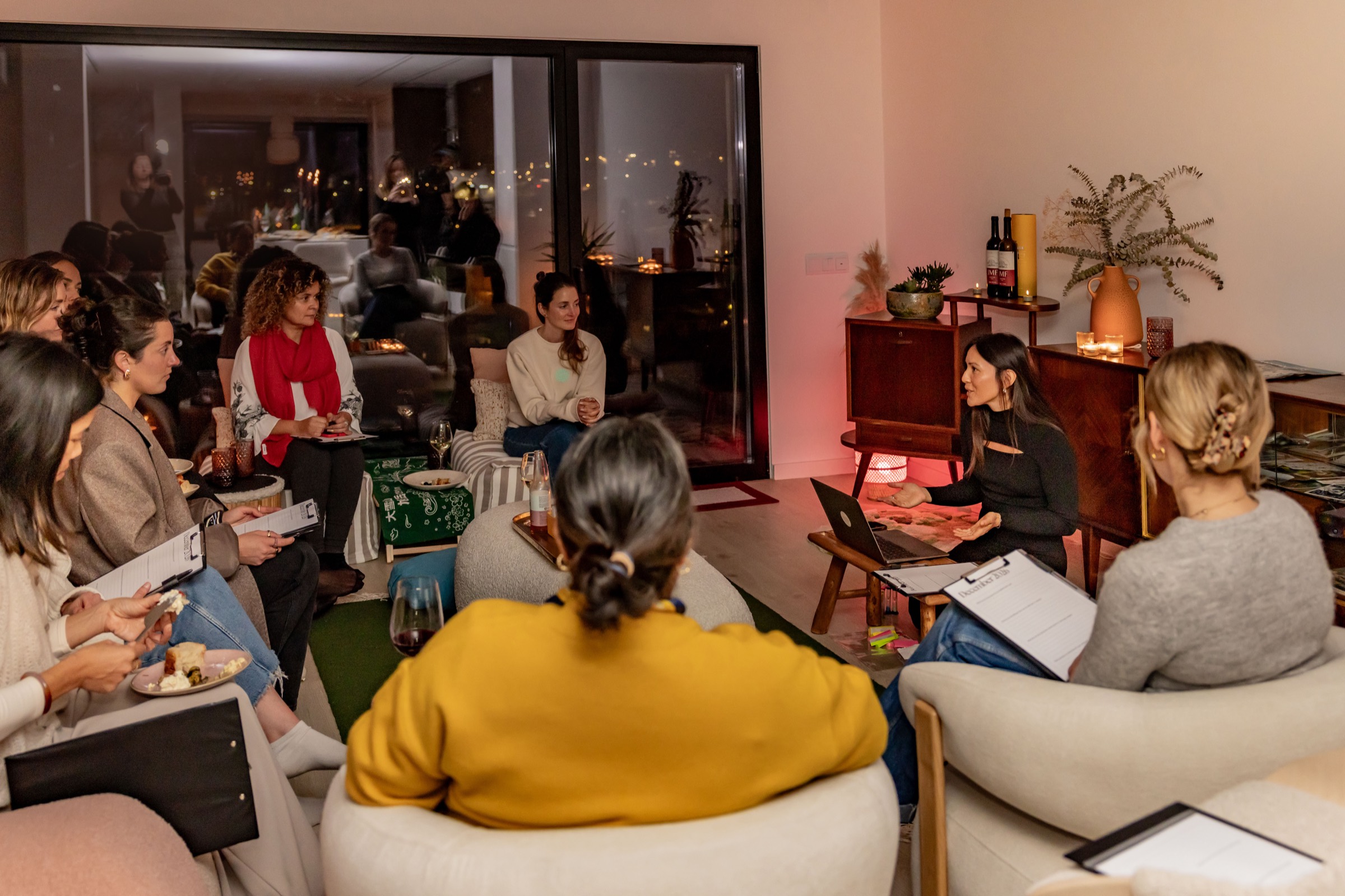 Jennifer Nunez leading an evening workshop in a living room